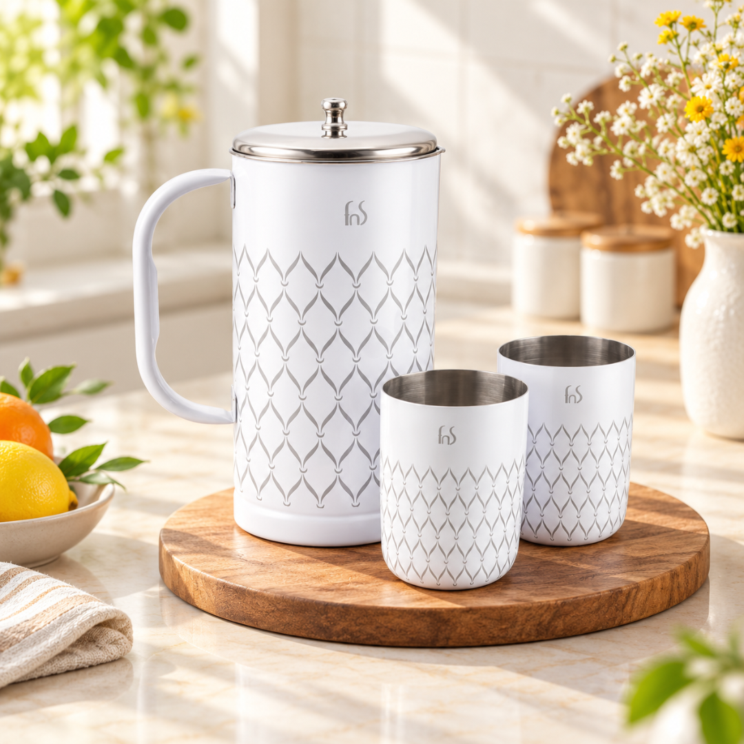 FnS Lecce 3-Pc white stainless steel water pitcher and two glasses displayed on a wooden board in a bright home kitchen.