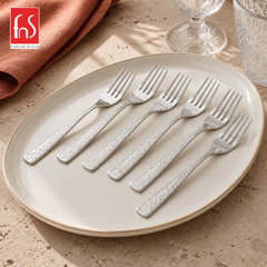 Montavo by FnS Pacific 6-piece stainless steel dinner fork set with textured handles arranged on a large elegant plate.