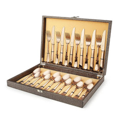 Complete rose gold cutlery set neatly organized inside textured leatherite box with beige velvet lining.