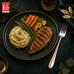 FnS Tivoli stainless steel dinner fork with 24 Karat gold plated handle beside grilled chicken and vegetables on plate
