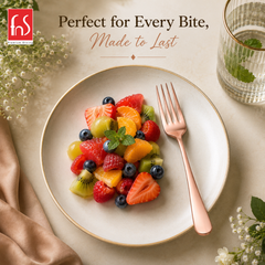 FnS Rosella rose gold stainless steel dinner fork served beside fresh mixed fruits in an elegant premium dining setup
