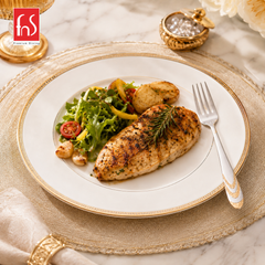 Montavo by FnS Magna 24 Karat gold plated dinner fork served beside grilled chicken and salad on an elegant dining plate