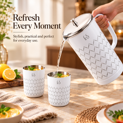 FnS Lecce white stainless steel pitcher pouring a chilled drink into matching glasses, styled for everyday refreshment.