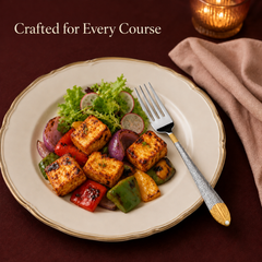 Montavo by FnS Passion real gold-plated dinner fork served beside grilled paneer and vegetables on an elegant white plate.
