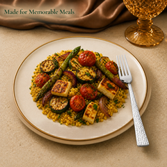 Montavo by FnS Helios stainless steel dessert fork served beside grilled paneer, asparagus and vegetables on a plate.
