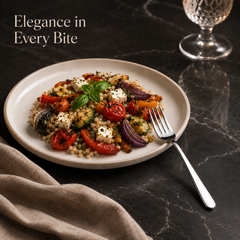 Montavo by FnS Verona stainless steel dessert fork served beside a colourful vegetable and cheese salad on a large plate.
