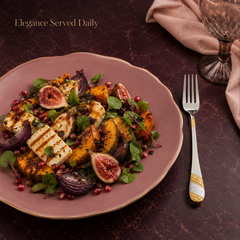 FnS Imperio 24K gold-plated stainless steel dinner fork served beside grilled paneer, figs and vegetables on a plate.
