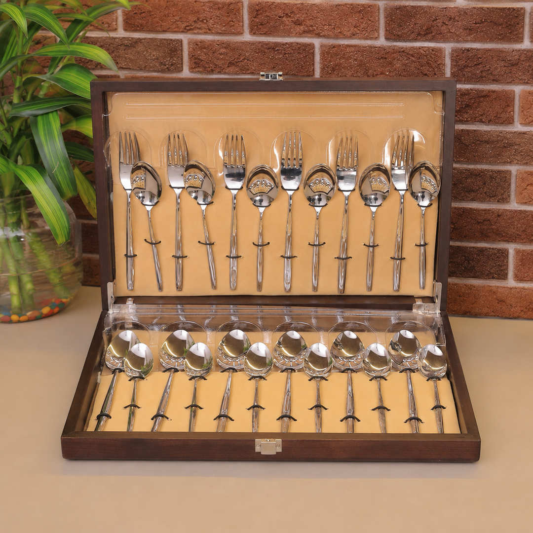 FNS Beau 24-piece stainless steel cutlery set with wooden storage box, including dinner forks, spoons, and serving spoons.