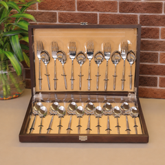 FNS Beau 24-piece stainless steel cutlery set with wooden storage box, including dinner forks, spoons, and serving spoons.