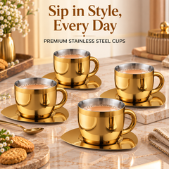 FnS Gold Stainless Steel Double Walled Tea Cup and Saucer Set with four cups filled with tea on a premium marble tabletop.
