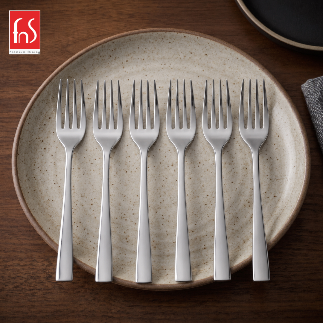 FnS Slimline stainless steel mirror finish dinner fork set of 6 arranged on a ceramic plate for elegant everyday dining