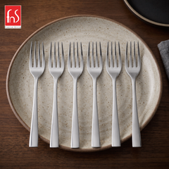 FnS Slimline stainless steel mirror finish dinner fork set of 6 arranged on a ceramic plate for elegant everyday dining