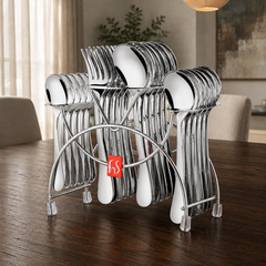 FnS Victoria 24-piece stainless steel cutlery set with hanging stand and red FnS badge on a luxury dark wood dining table.