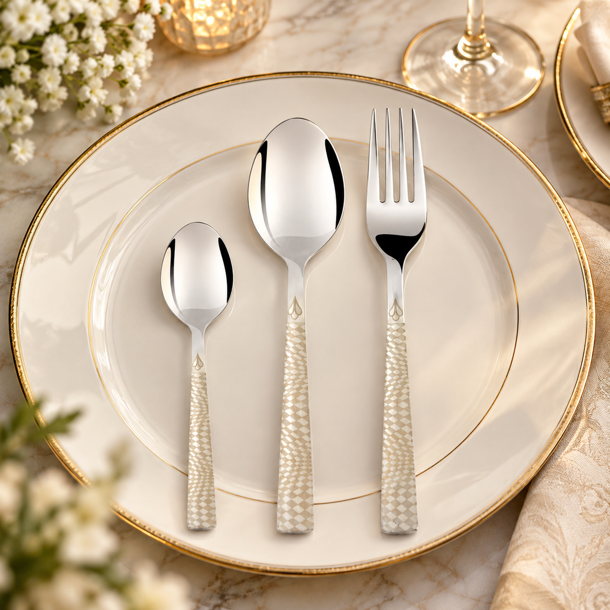 Montavo by FnS Lush 18 Pc laser engraved stainless steel cutlery set with spoon, teaspoon and fork on a plate.