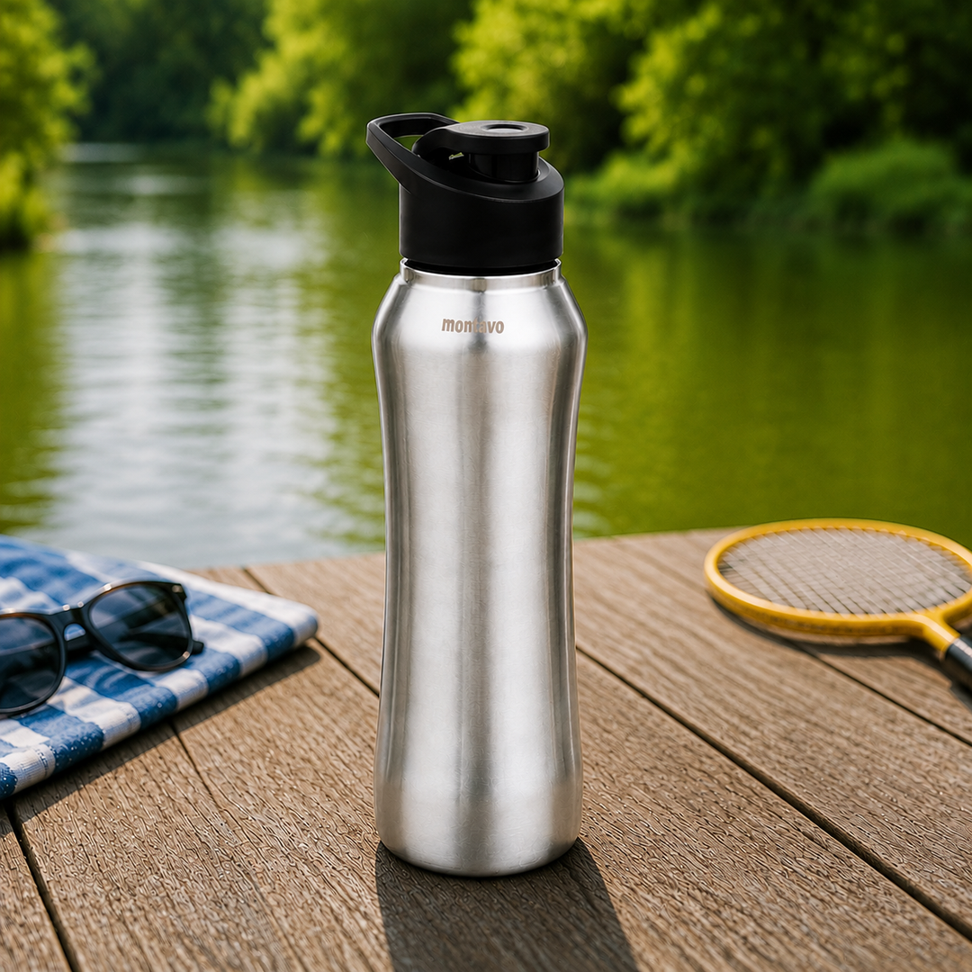 Montavo by FnS Reptide 1 litre stainless steel water bottle with black cap displayed outdoors on a wooden table by a lake