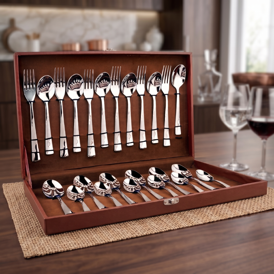 Montavo by FnS Creta 24 Pc stainless steel cutlery set neatly displayed in an open leatherette box on a wooden dining table