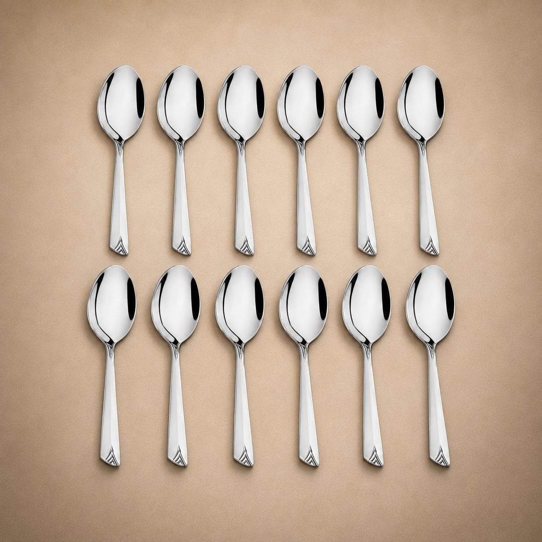 Montavo by FnS Divine 12-piece stainless steel soup spoon set arranged in two rows on a soft champagne luxury background.