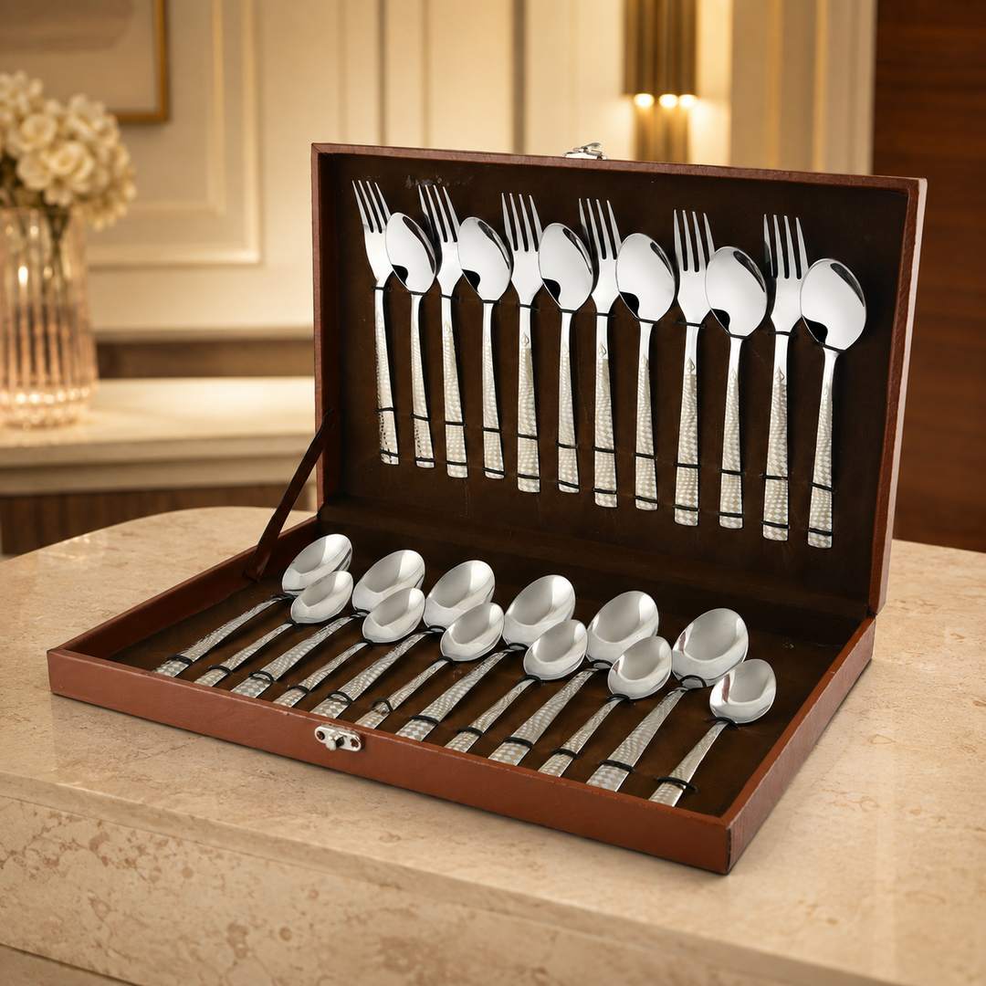 Montavo by FnS Lush 24-piece laser-engraved cutlery set in an open brown leatherette box in a premium dining setting.