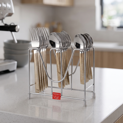 Montavo by FnS Pebble 18-piece laser-engraved cutlery set with spoons and forks arranged on a hanging stand in a kitchen.