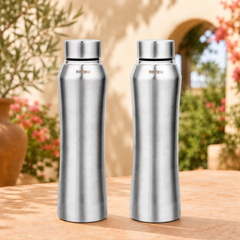Montavo by FnS Oasis 1 litre stainless steel water bottle set of 2 with silver caps displayed on a sunlit garden table.
