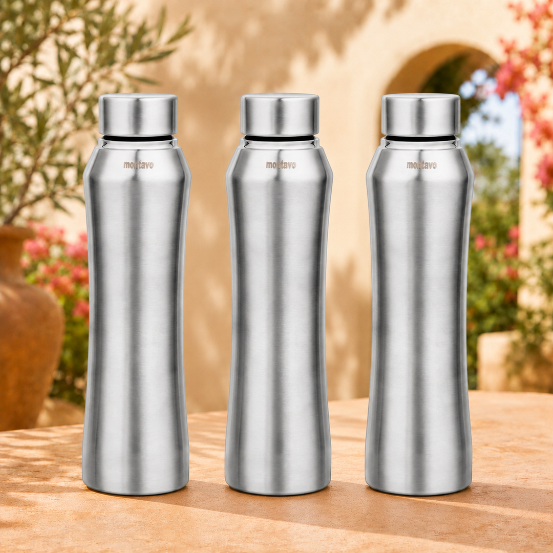Montavo by FnS Oasis 1 litre stainless steel water bottle set of 3 with silver caps displayed on a sunlit garden table
