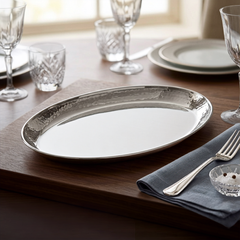 FnS Stainless Steel Oval Deep Platter with hammered finish displayed on a premium dining table for elegant serving.
