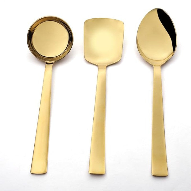Top view of Alexa gold serving utensils showing gravy ladle, rice server, and large serving spoon in mirror finish