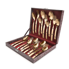 18-piece rose gold cutlery set displayed inside an open leatherite box with red velvet interior.