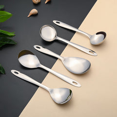Amazon serving spoons arranged diagonally with decorative shells and natural elements, highlighting premium stainless steel quality and contemporary styling for modern kitchens.