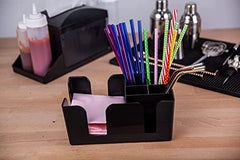 Compact black bar caddy holding colorful metallic straws and pink napkins on wooden bar counter with bartending equipment