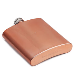 Bottom view of copper hip flask showing smooth rounded base with engraved "STAINLESS STEEL 7 OZ" text marking