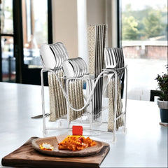 Elegant 24-piece cutlery set in patterned handles, organized in stand, styled on modern counter.