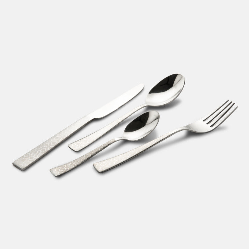 Four-piece cutlery set laid diagonally, showcasing engraved handles and polished silver finish.