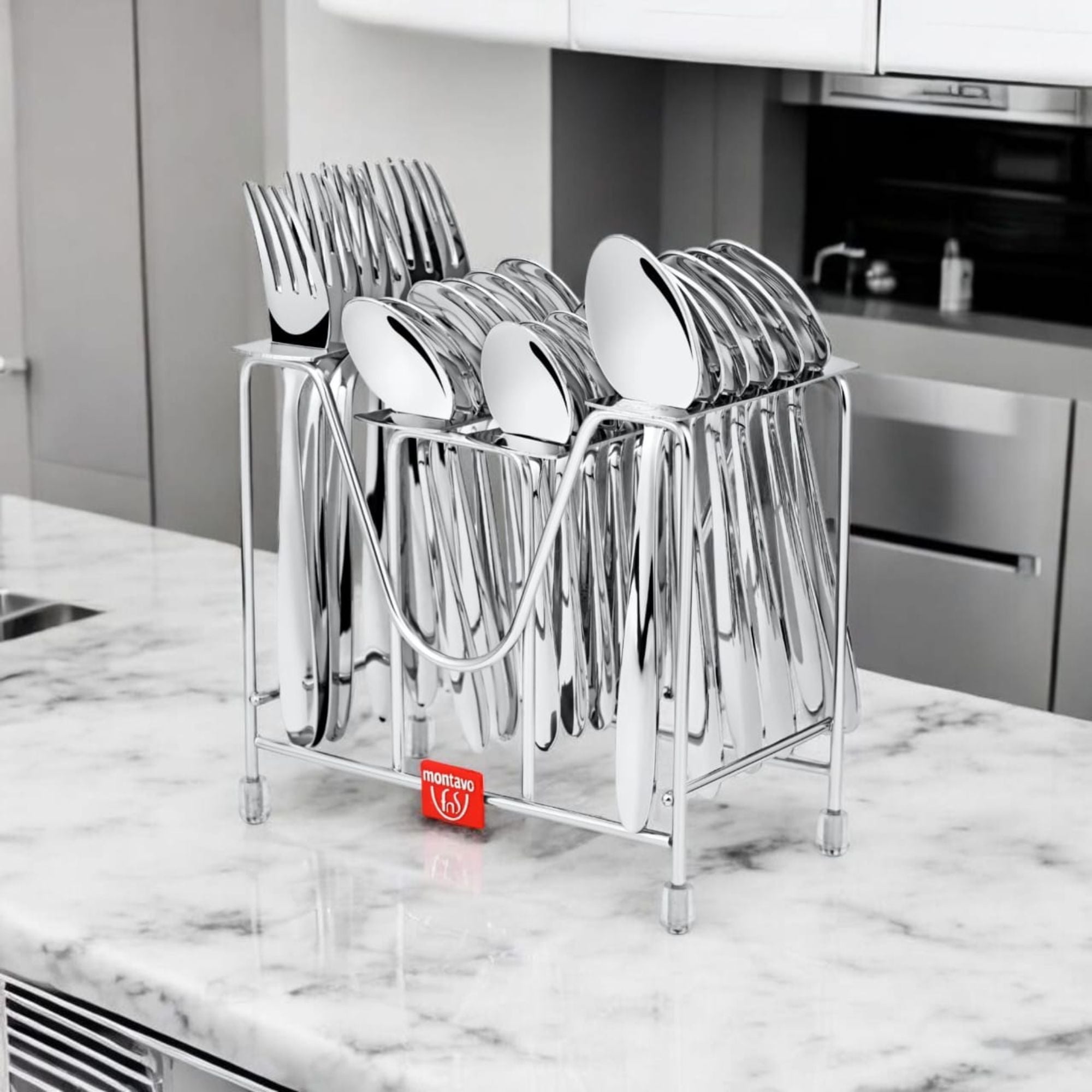 Polished stainless steel cutlery neatly organized in a metal holder on a marble kitchen counter.