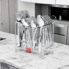 Polished stainless steel cutlery neatly organized in a metal holder on a marble kitchen counter.