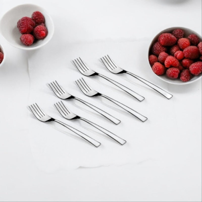 Six stainless steel forks arranged with bowls of fresh raspberries