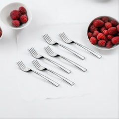 Six stainless steel forks arranged with bowls of fresh raspberries