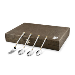 Four cutlery pieces with decorative handles laid on closed brown box with secure metal latch.