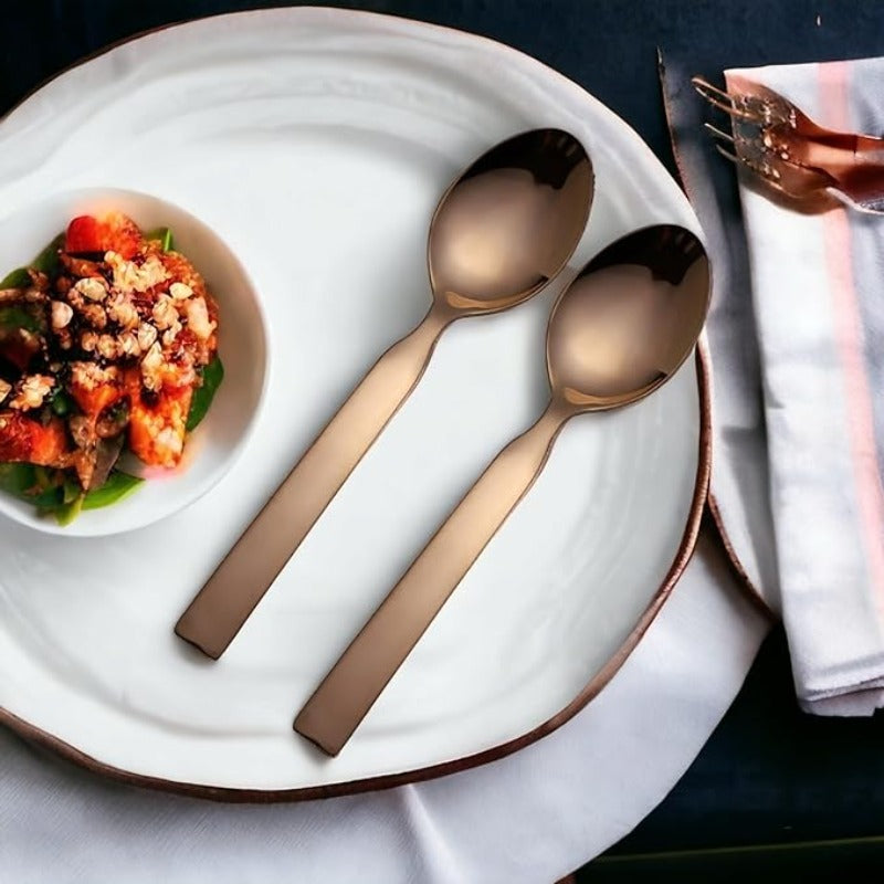 FNS Allie rose gold baby spoon set elegantly placed on white plate with gourmet appetizer, showcasing premium dining experience and modern table setting.