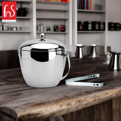 FNS apple-shaped ice bucket with mirror finish and lid on rustic wooden bar counter with ice tongs and modern bar background