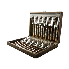 Complete cutlery set with golden design organized inside an open brown storage and display box.
