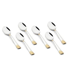 Six stainless steel teaspoons with mirror-polished bowls and gold-textured handle tips arranged in two rows on white background