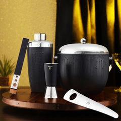 FNS 5-piece black bar tool set lifestyle shot with water droplets on copper tray with gold and black decor