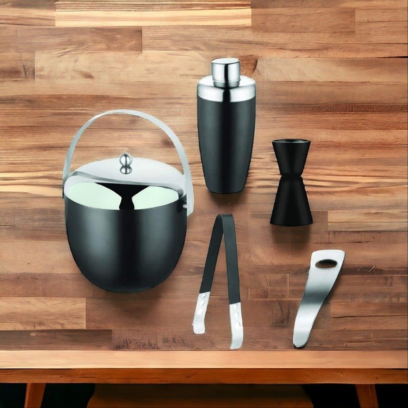 FNS 5-piece black matte bar tool set with ice bucket, shaker, jigger, tongs, and bottle opener on wooden table