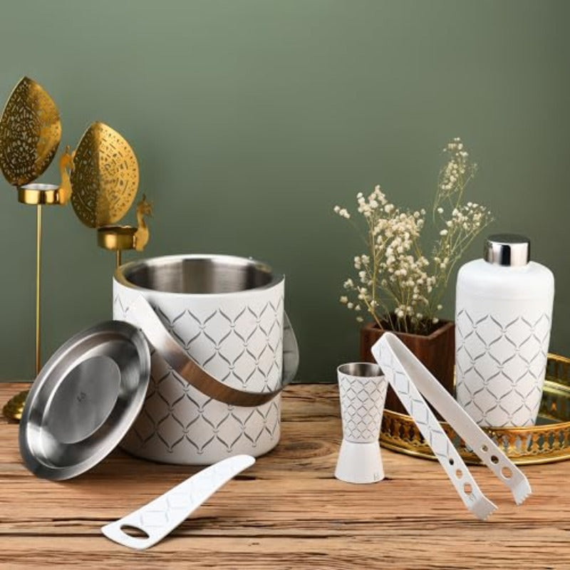 FNS 5-piece bar tool set in white with diamond pattern displayed on wooden table with gold decor and green wall