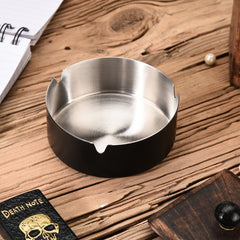 FNS black stainless steel ashtray on rustic wooden desk with notebook and drawer for home or office use