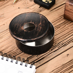 FNS black wooden finish ashtray with removable lid on rustic wood desk with notebook and pen lifestyle setting