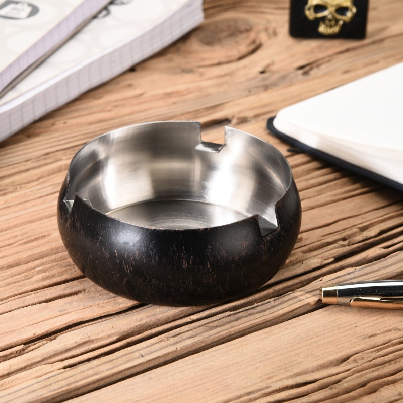 FNS black wooden finish stainless steel ashtray on rustic wood desk with notebook and pen lifestyle setting