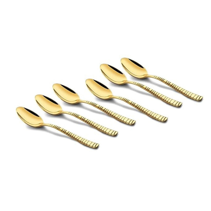 FNS Boston 6-piece stainless steel gold dessert spoon set arranged artistically, featuring ribbed handles and luxurious mirror gold finish for premium dining.
