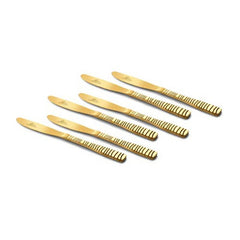 Set of six gold dinner knives with patterned textured handles arranged at angle on white background for premium product presentation and elegant dining display photography.